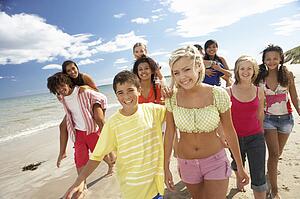 Teenagers walking on beach