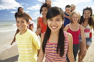 Teenagers walking on beach
