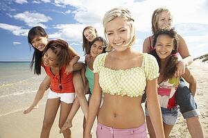 Teenage girls walking on beach