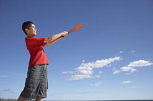 Teenage boy playing baseball