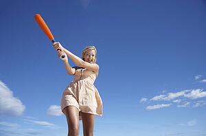 Teenage girl playing baseball