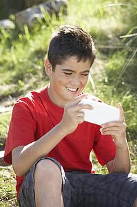 Teenage boy playing with computer game