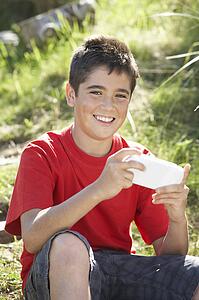 Teenage boy playing with computer game