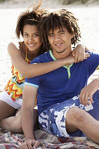 Portrait teenage couple on beach