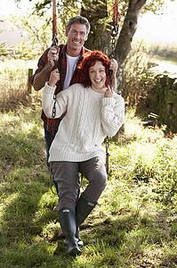 Couple with country garden swing