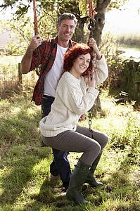 Couple with country garden swing