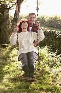 Couple with country garden swing
