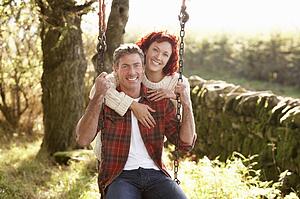 Couple with country garden swing