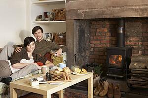 Young couple relaxing by fire