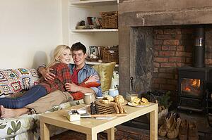 Young couple relaxing by fire