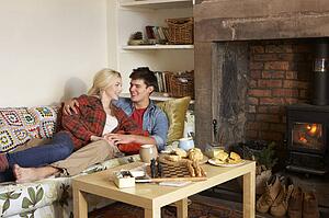 Young couple relaxing by fire
