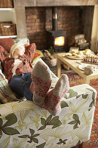 Young woman relaxing by fire