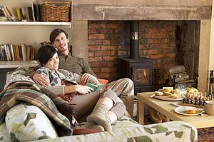 Young couple relaxing by fire