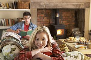 Young couple relaxing by fire