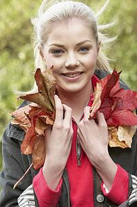 Young woman with autumn leaves