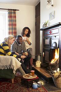Young adults making toast on open fire