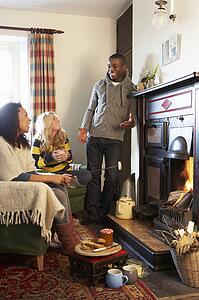 Young adults making toast on open fire