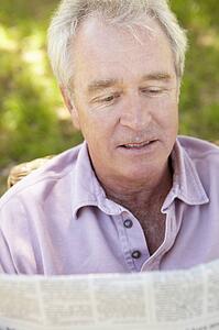 Senior man reading newspaper
