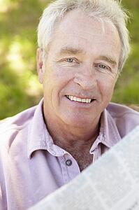 Senior man reading newspaper