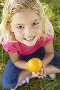 Portrait of happy girl with orange