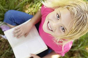 Portrait of happy girl with book