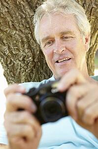 Senior man with camera