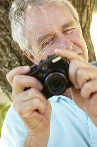 Senior man with camera
