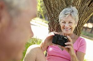 Senior woman with camera
