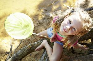 Happy girl fishing at lake
