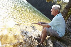 Senior man fishing at lake