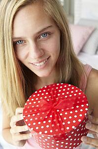Teenage girl holding gift box