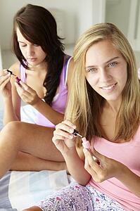 Teenage girls painting nails