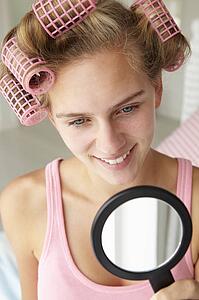 Teenage girl with hair in curlers