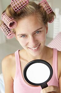 Teenage girl with hair in curlers