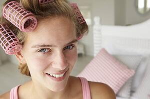 Teenage girl with hair in curlers