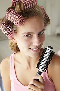 Teenage girl with hair in curlers