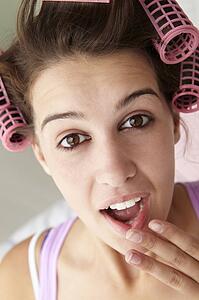 Teenage girl with hair in curlers