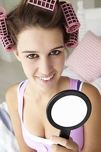 Teenage girl with hair in curlers