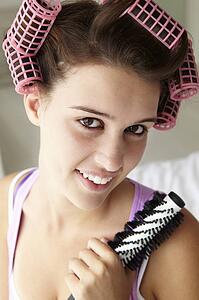 Teenage girl with hair in curlers