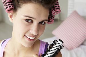 Teenage girl with hair in curlers