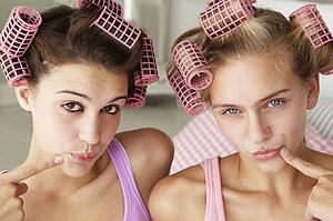 Teenage girls with hair in curlers