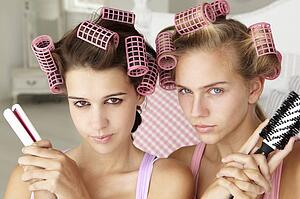 Teenage girls with hair in curlers