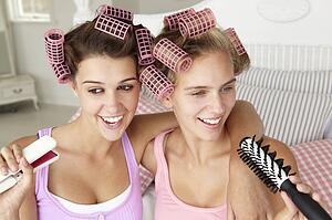 Teenage girls with hair in curlers