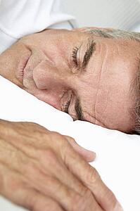 Head and shoulders mid age man sleeping