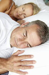 Head and shoulders mid age couple sleeping