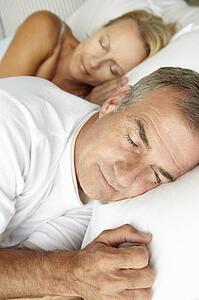 Head and shoulders mid age couple sleeping