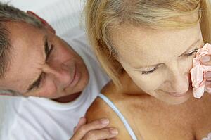 Man comforting crying wife