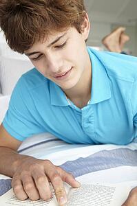 Teenage boy reading a book