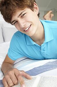 Teenage boy reading a book