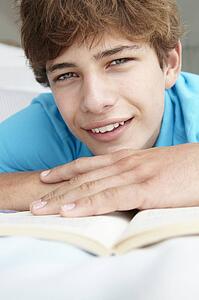 Teenage boy reading a book